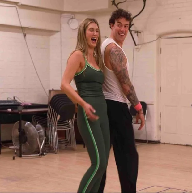 Delta Goodrem and Kai Widdrington laughing during a rehearsal.