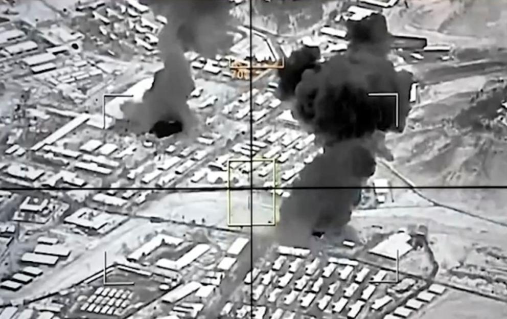 Aerial image, in thermal vision, showing multiple explosions in a city with text "Airstrikes at Kabul".