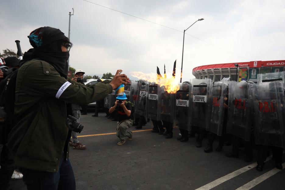 Demonstrators clash with police during the World Cup opener in Mexico City