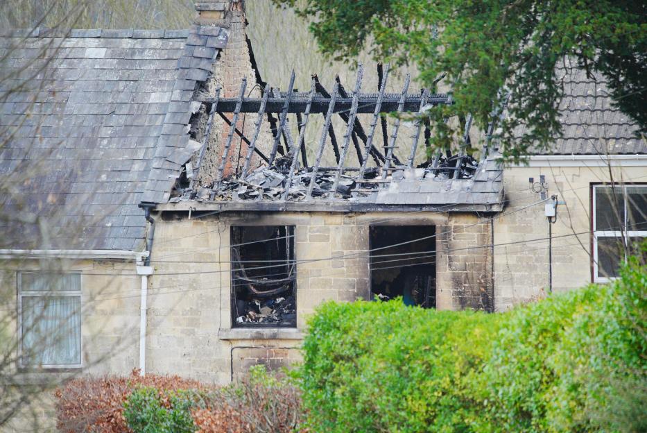 Damaged roof and charred timbers of a property in Brimscombe.