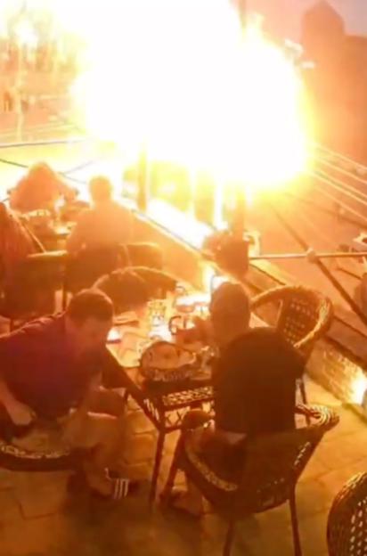 'Shocking Scene: Balloons Burst into Fireball Near Busy Restaurant Terrace After Striking Power Lines'