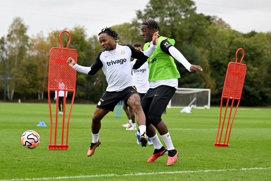 Raheem Sterling and Axel Disasi of Chelsea train on a soccer field.