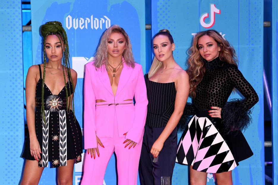 Little Mix, from left to right: Leigh-Anne Pinnock, Jesy Nelson, Perrie Edwards, and Jade Thirlwall posing on the red carpet.