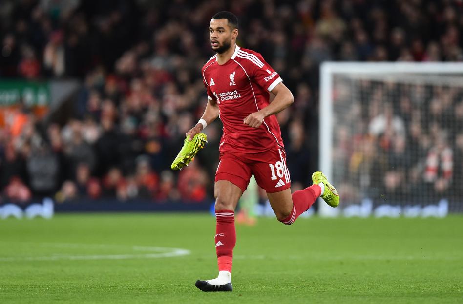 Liverpool's Cody Gakpo runs with one boot off during an FA Cup match.