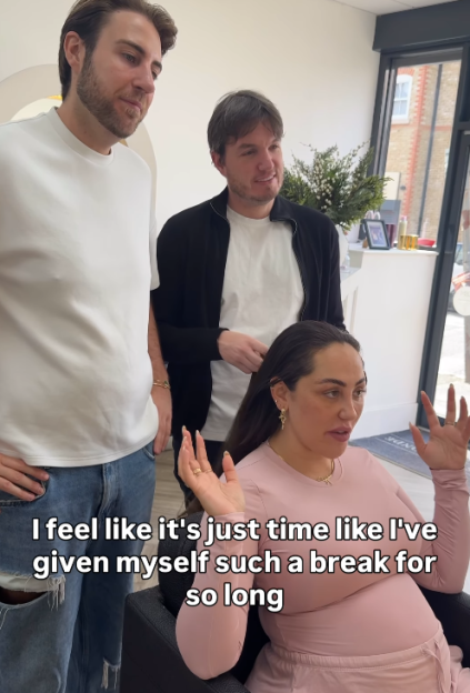 A woman in a pink top talks with two men standing behind her, with text overlaid that reads: "I feel like it's just time like I've given myself such a break for so long."