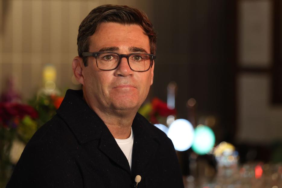 Mayor of Greater Manchester Andy Burnham wearing glasses and a black jacket.