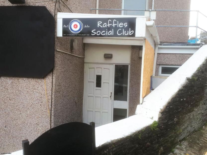 Raffles Social Club, Plymouth, with its entrance door and sign that reads "Raffles Social Club" and "Phil & Julie: 'a nice place for nice people'".