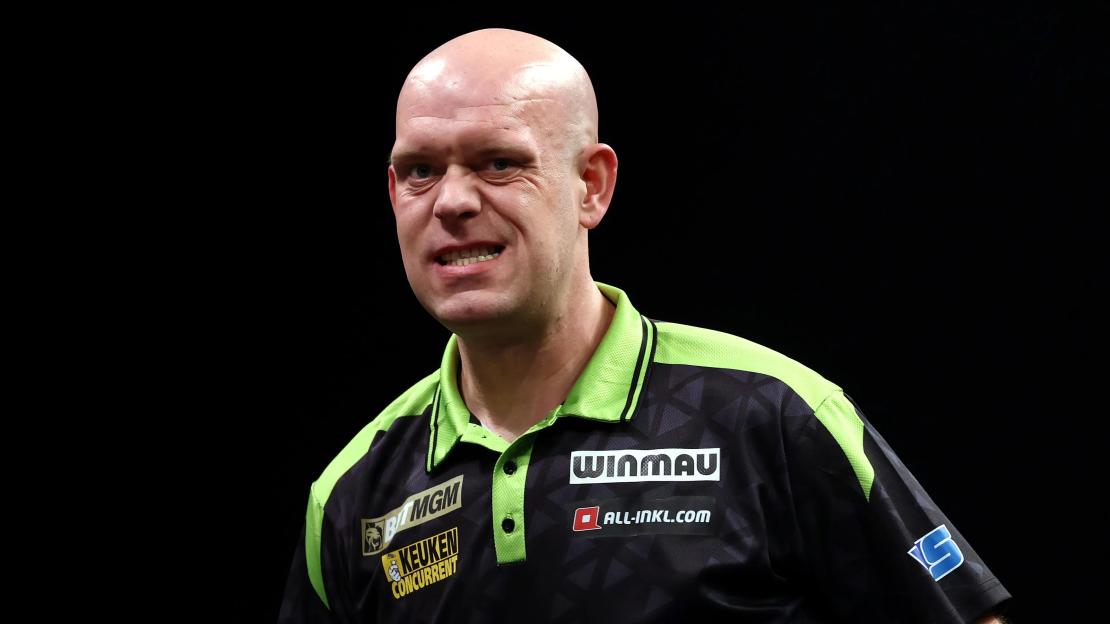 Dutch darts player Michael van Gerwen reacts during a match, showing a strained facial expression.