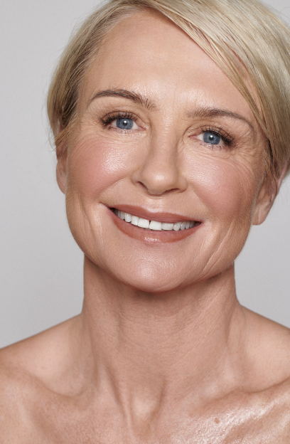 Headshot of smiling Model Jo Skinner with short blonde hair and blue eyes.