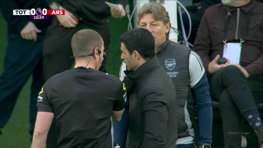 Arsenal coach Mikel Arteta talking with the referee during a match stoppage due to an IT issue.