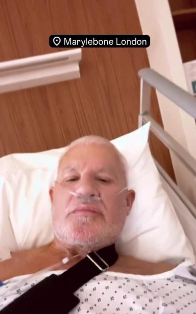 Wayne Lineker in a hospital bed with tubes in his nose and a shoulder sling.