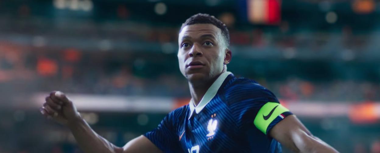 Kylian Mbappé on a football field.