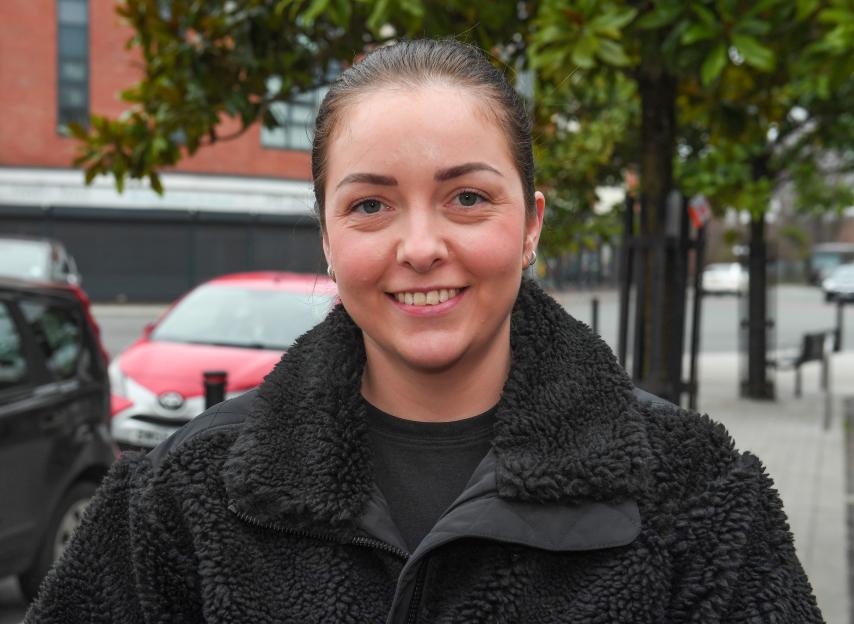 Katie Chisnall smiling at the camera, wearing a black fluffy jacket.