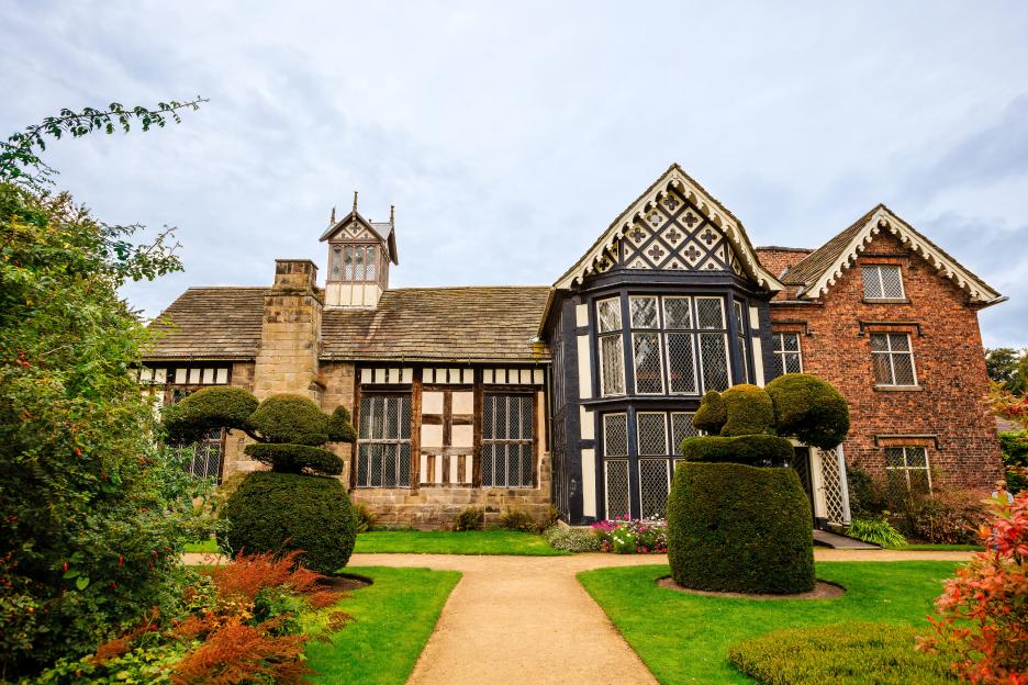 Rufford Old Hall, an Elizabethan mansion with half-timbered and brick sections, and a landscaped garden.