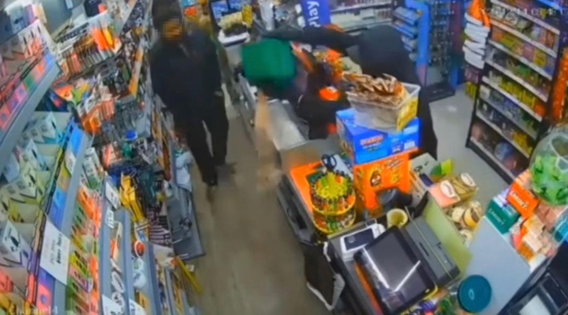 CCTV footage of a shopkeeper confronting a masked robber who poured petrol on the shop floor.
