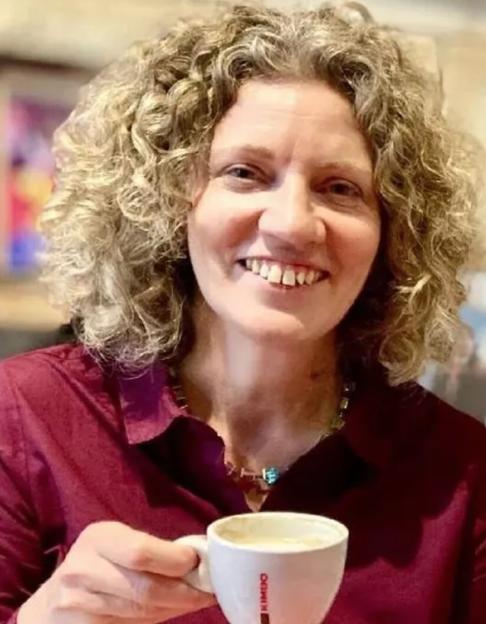 Lynda Shahwan, a BBC journalist, holding a cup of coffee.