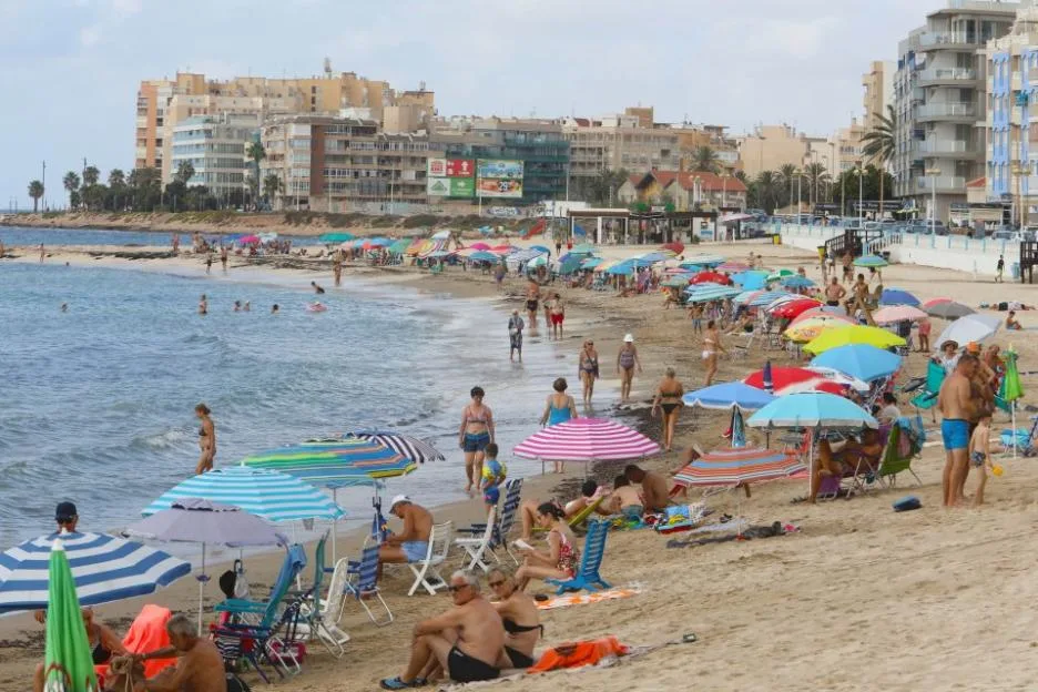 A view of the Torrevieja town beach on Spain's Costa Blanca with apartment buildings in the background.