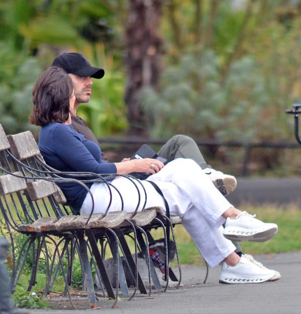 Shirley Ballas and Giuseppe Nonnis sitting close on a park bench.