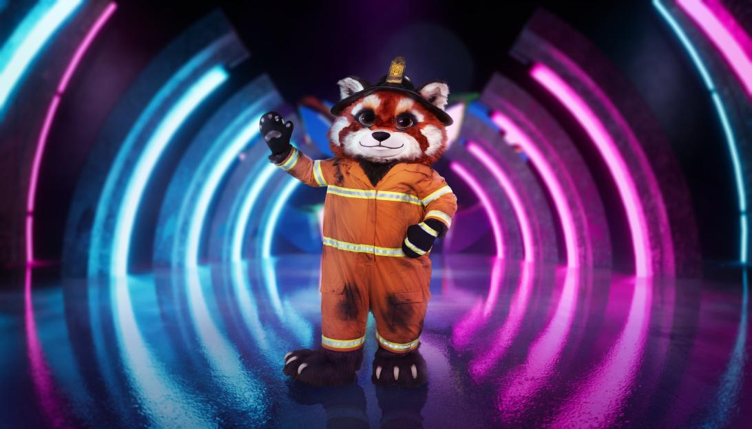 Red Panda in a firefighter uniform and helmet waving.