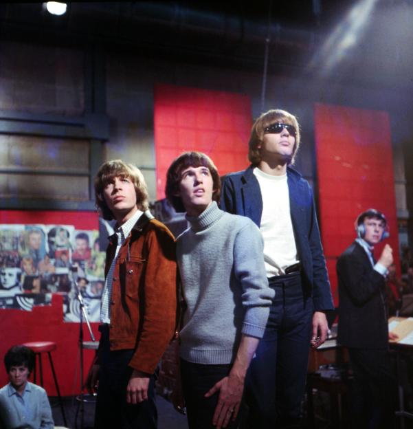 Members of the Walker Brothers performing on stage.