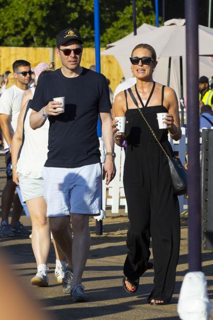 Cat Deeley and Charlie Coleman walking at American Express presents BST in Hyde Park.