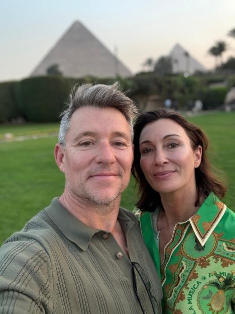 Ben Shepherd with his wife in front of pyramids in Egypt.