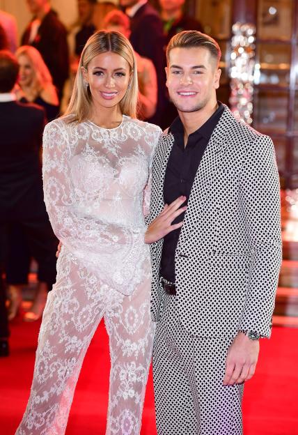 Olivia Attwood and Chris Hughes smiling and posing for a photo.