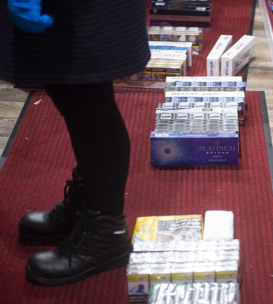 Stacks of illegal cigarettes and vapes discovered during a police raid on a shop in Blackburn.