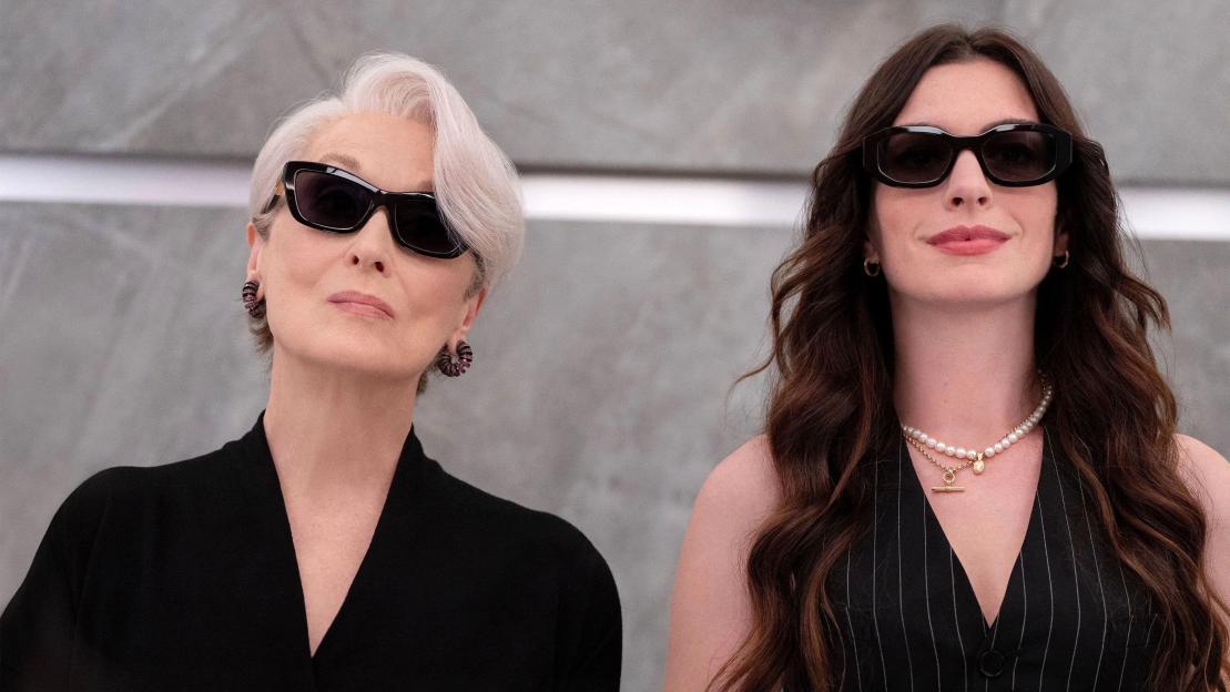 A scene from The Devil Wears Prada 2 with Anne Hathaway and Meryl Streep wearing sunglasses.