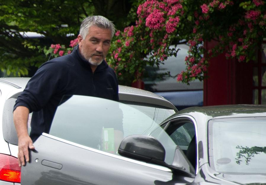 Paul Hollywood getting into his Aston Martin with a box of Shreddies.
