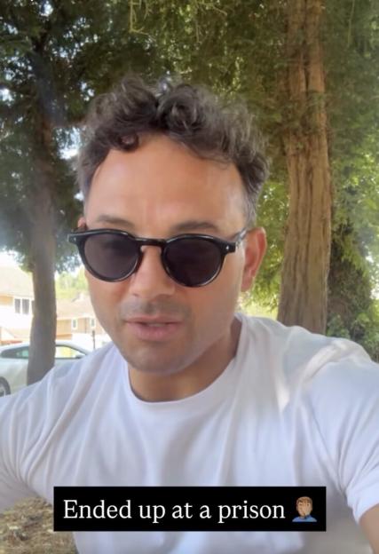 Ryan Thomas wearing sunglasses and a white t-shirt, with text overlay "Ended up at a prison".