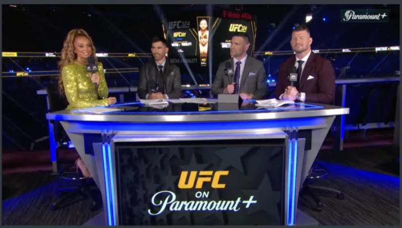 Four commentators, three men and one woman, sit at a desk with "UFC on Paramount+" displayed on the front.