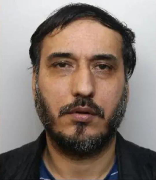 Obaidullah Omari, a man with dark hair and a beard, looks directly at the viewer.