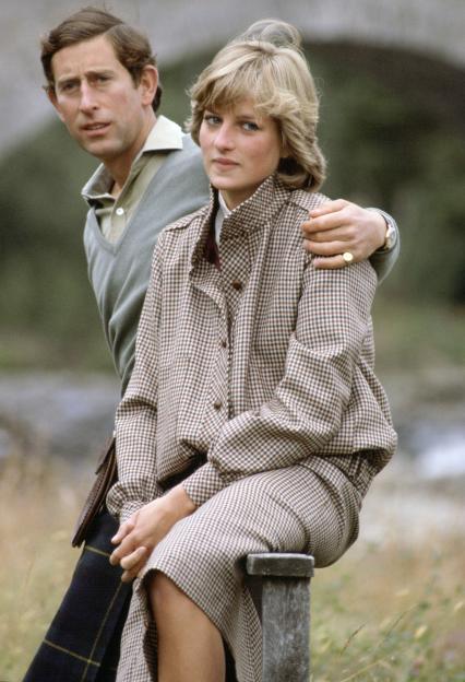 Prince Charles with his arm around Princess Diana as they sit on a style during their honeymoon at Balmoral in Scotland.