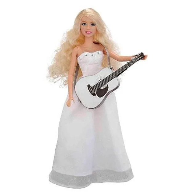 Taylor Swift doll wearing a white dress and holding a white guitar.