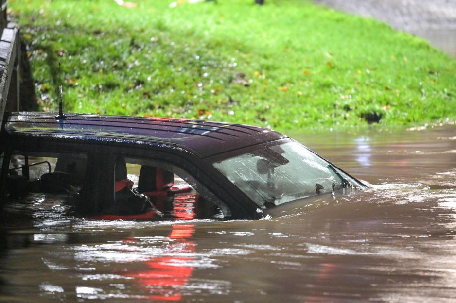 Green Road, Birmingham, Nov 14th 2025 - A 4x4 has been abandoned after the driver risked navigating a flooded ford in the Hall Green area of Birmingham on Friday night. Smashed windows could be seen suggesting the occupants were unable to open the do