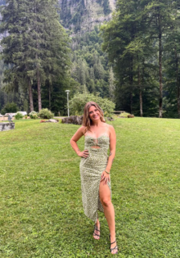 Hana Carter smiling in a green dress.