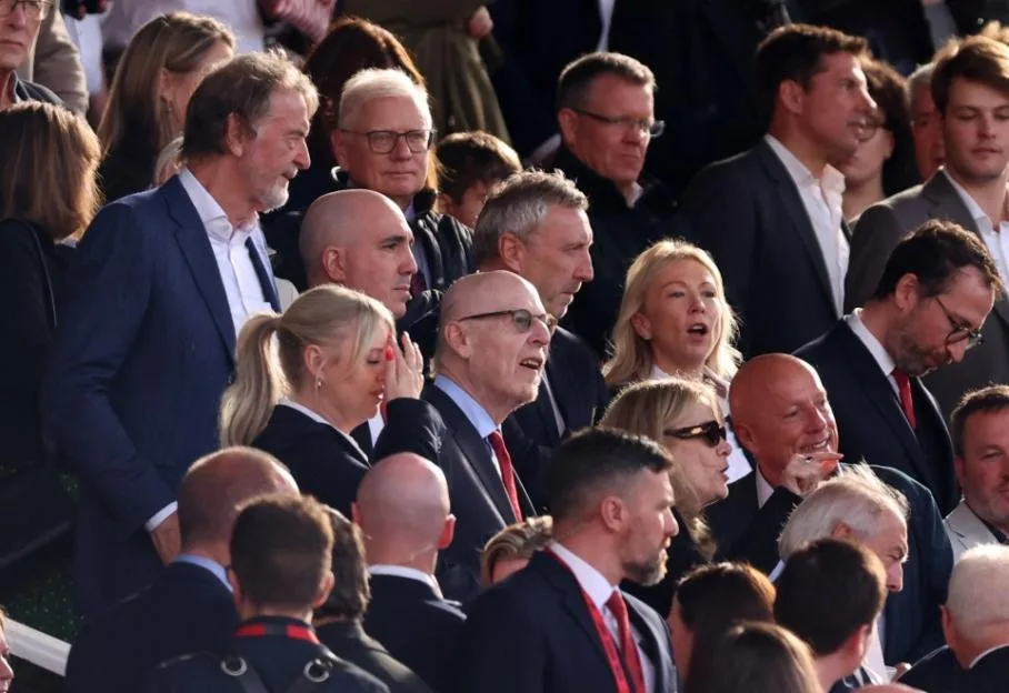 Manchester United executives and owners, including Avram Glazer and Sir Jim Ratcliffe, seated in the stands at Old Trafford.