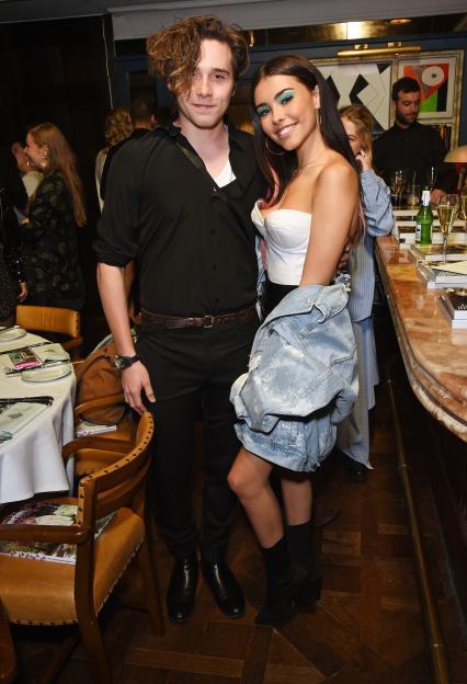 Brooklyn Beckham and Madison Beer posing together at a Wonderland Summer Issue dinner.