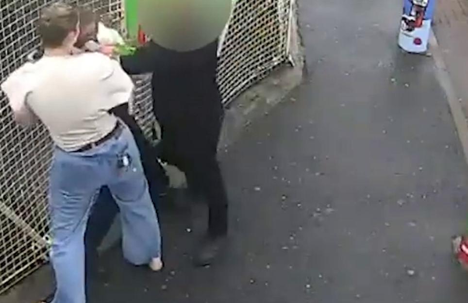 Nicholas Noble being restrained by a member of staff and PC Alice O'Brien.