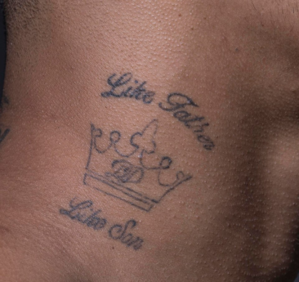 Tattoo on skin depicting a crown with the words "Like Father" above it and "Like Son" below it.