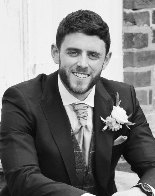 Photo of PC Andrew Harper smiling in a suit.