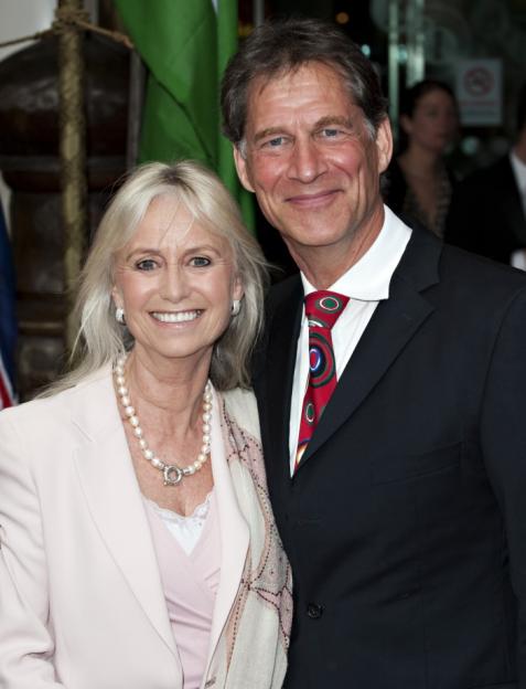 A smiling man and woman posing for a photo at the Royal Premiere of Arabia.