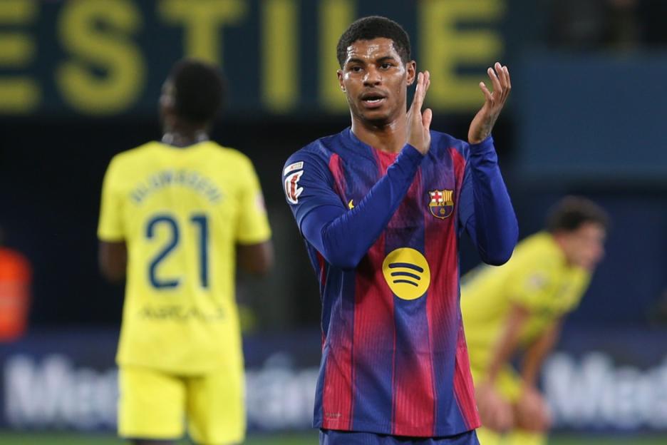 A Barcelona soccer player in a blue and red striped jersey clapping.