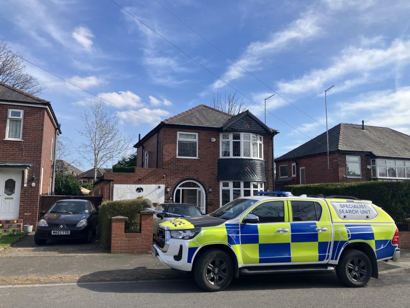 Police vehicle parked outside a house on Butterstile Lane in Prestwich, Bury.