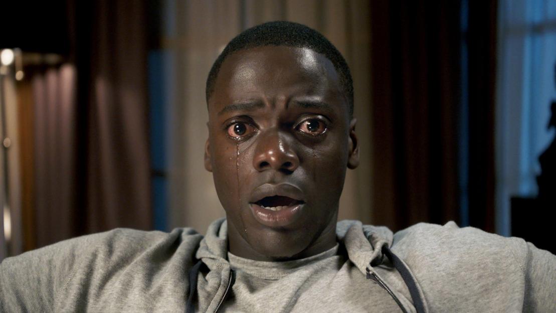 Daniel Kaluuya as Chris Washington crying with red eyes and an open mouth in a still from the film Get Out.