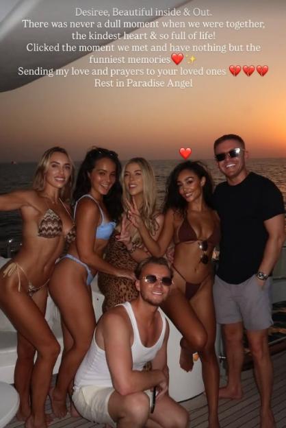 A group of six friends posing for a photo on a boat, with overlay text expressing condolences.