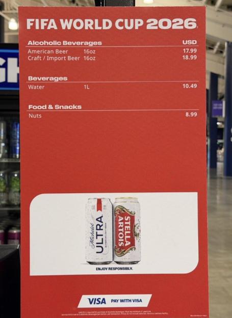 Sign listing FIFA World Cup 2026 prices for American Beer ($17.99), Craft/Import Beer ($18.99), Water ($10.49), and Nuts ($8.99).