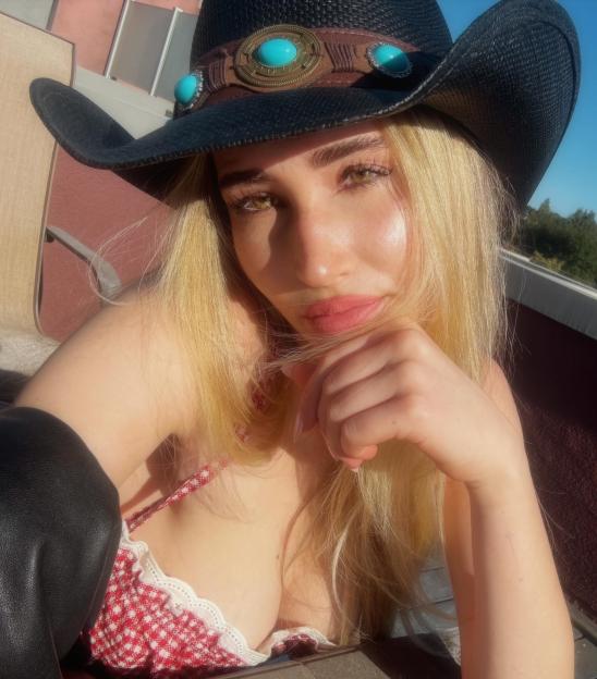 Auden Wyle in a black cowboy hat with a red and white top.