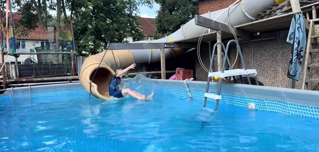Brit dad builds own 'mini waterpark' by installing huge WATERSLIDE from garage to garden